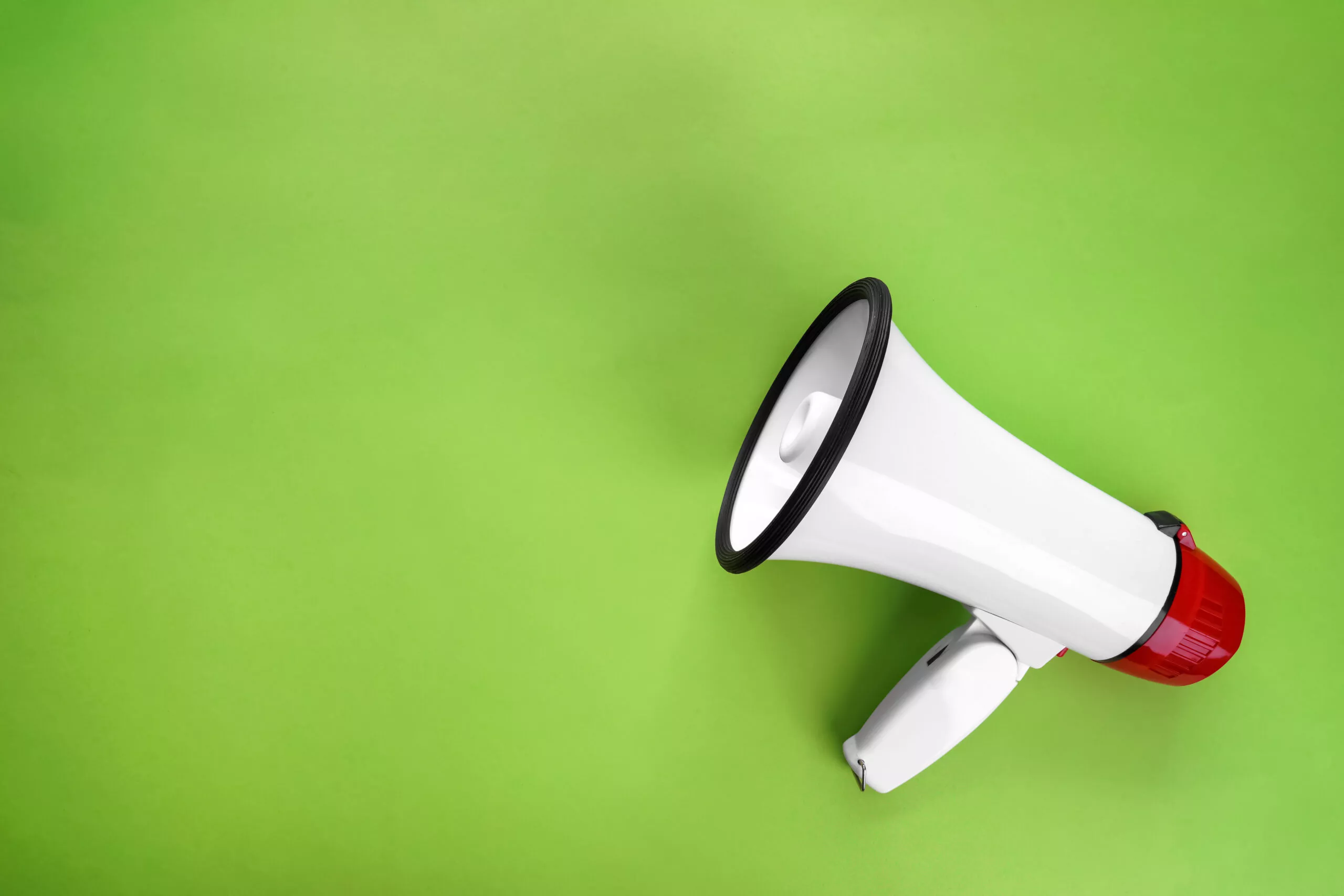 Megaphone on color background